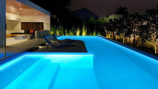 Modern swimming pool illuminated with pool LED strip lights at night