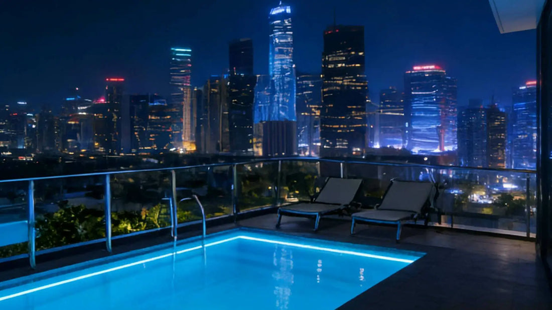 rooftop infinity pool with LED strip lighting at night overlooking city skyline